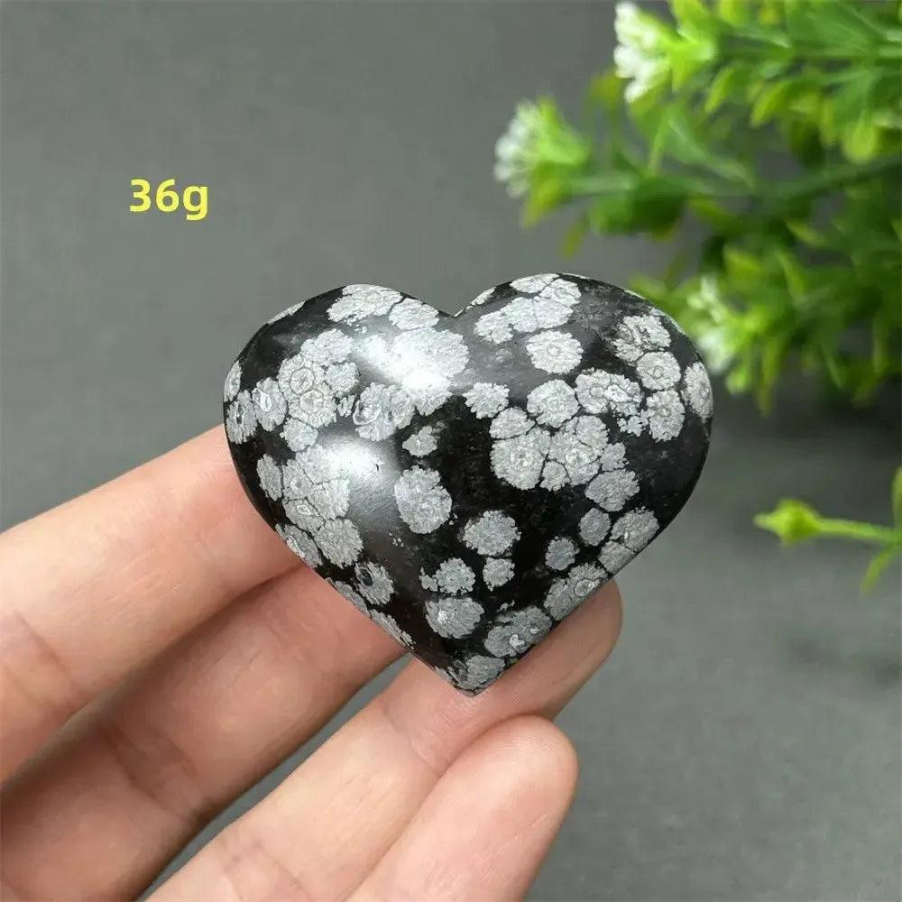 Polished Snowflake Obsidian Crystal Heart, 36g. Black volcanic glass with white snowflake patterns for grounding and transformation.
