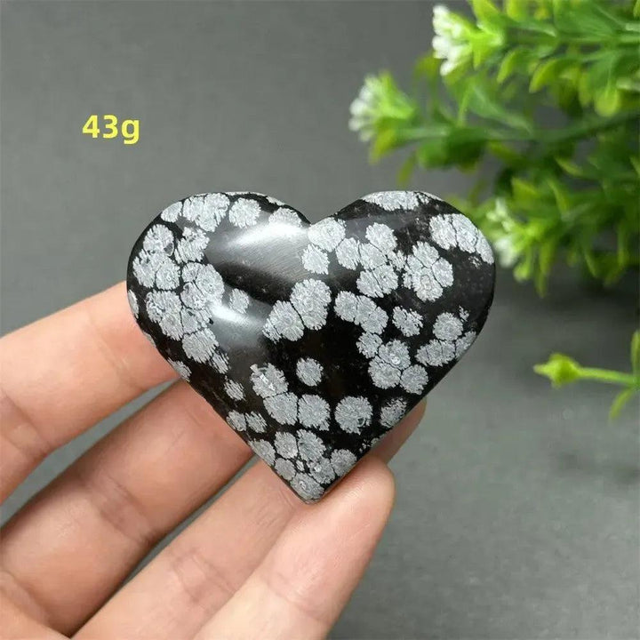Polished Snowflake Obsidian Crystal Heart, 43g, showcasing black volcanic glass with white snowflake patterns for grounding and healing.
