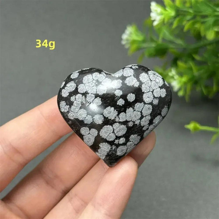 Polished Snowflake Obsidian Crystal Heart, 34g, showcasing black volcanic glass with white snowflake patterns.