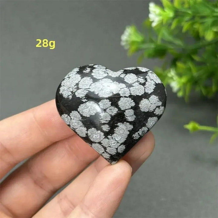 Snowflake Obsidian Crystal Heart: Polished black stone with white snowflake patterns, weighing 28g. Grounding and protective.