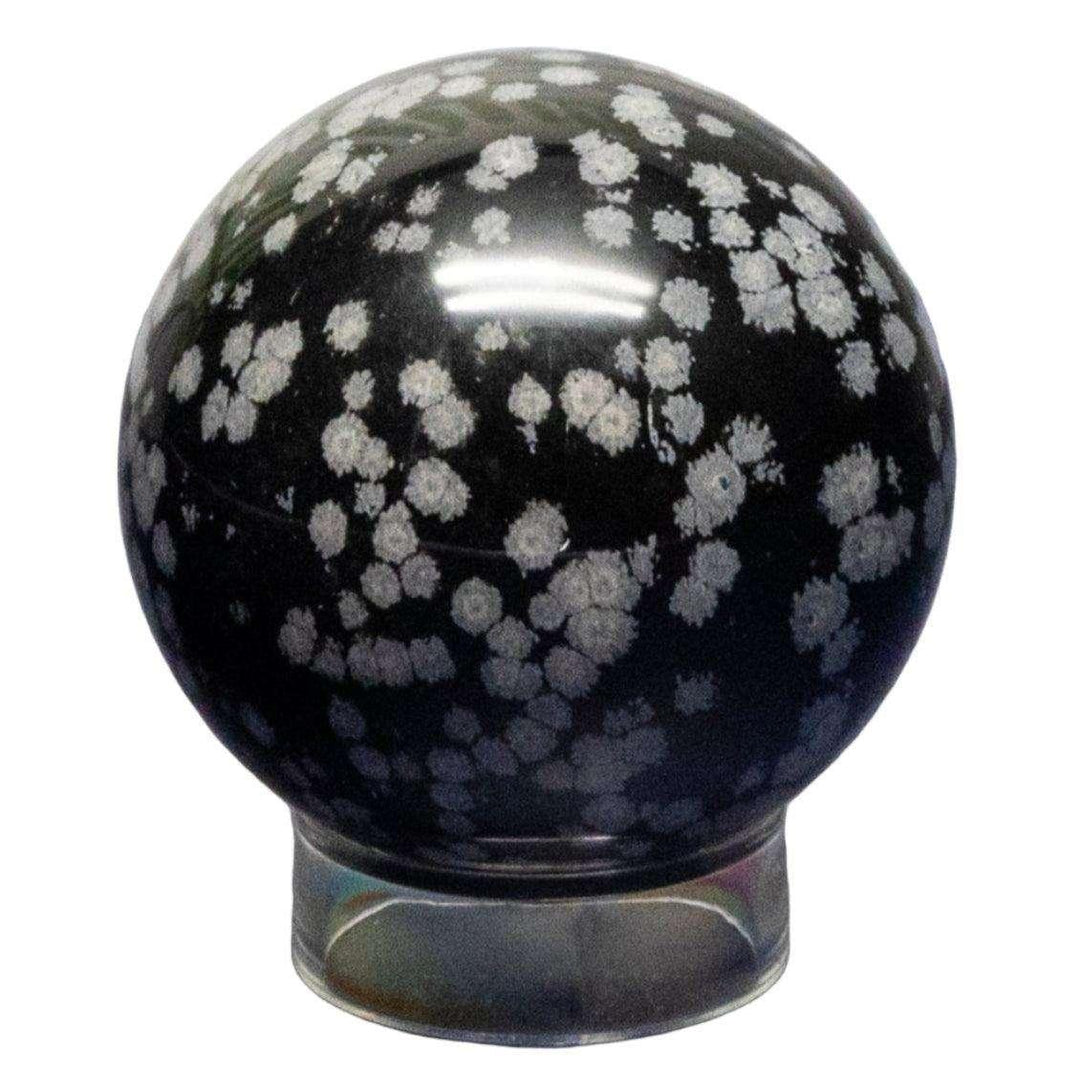 Snowflake Obsidian Sphere 50-52mm, a polished black volcanic glass with distinctive white snowflake patterns.