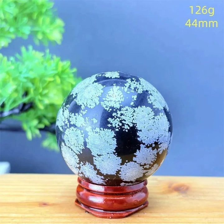 Snowflake Obsidian Sphere: Deep black volcanic crystal with delicate white snowflake patterns, 44mm, for grounding and protection.