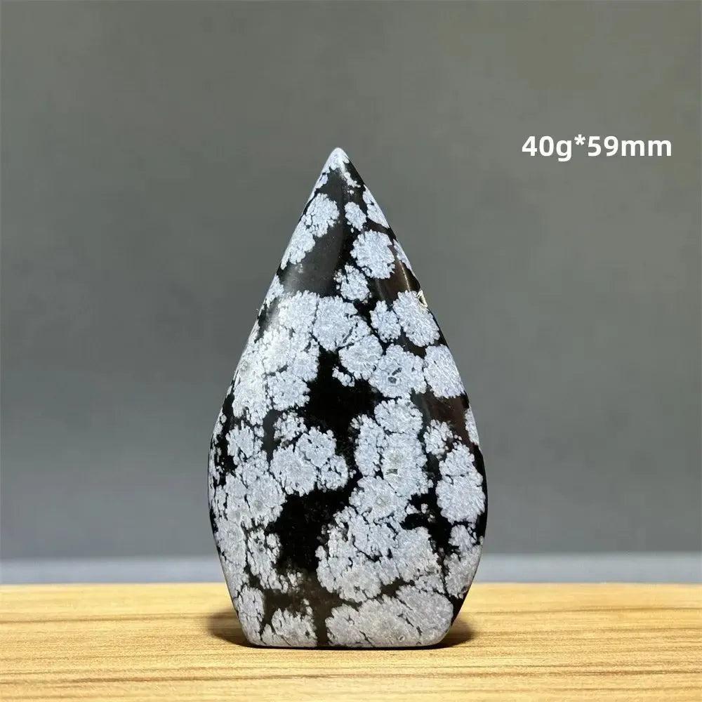 Snowflake Obsidian freeform torch from Crystal Destiny, a black crystal with white snowflake patterns.