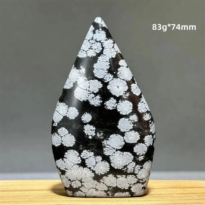 Snowflake Obsidian freeform torch from Crystal Destiny, featuring black volcanic glass with white snowflake patterns.