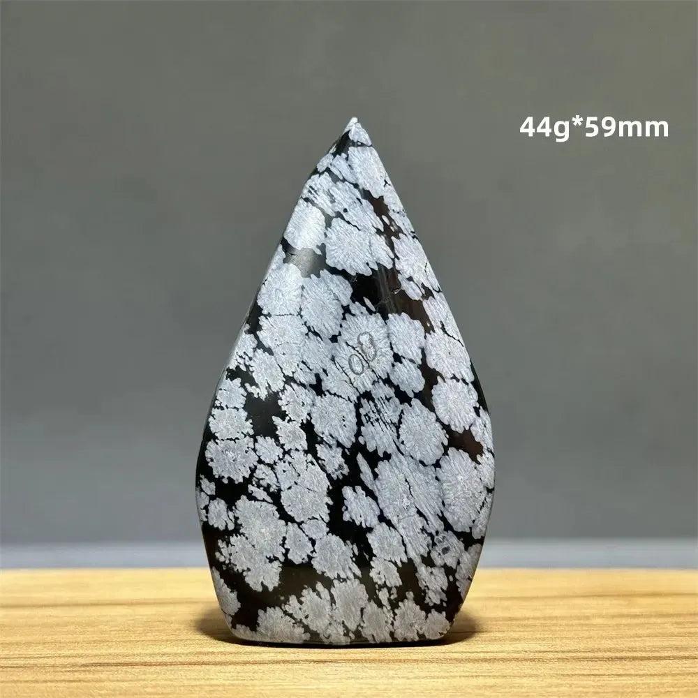 Snowflake Obsidian freeform torch from Crystal Destiny, featuring black volcanic glass with white snowflake patterns.