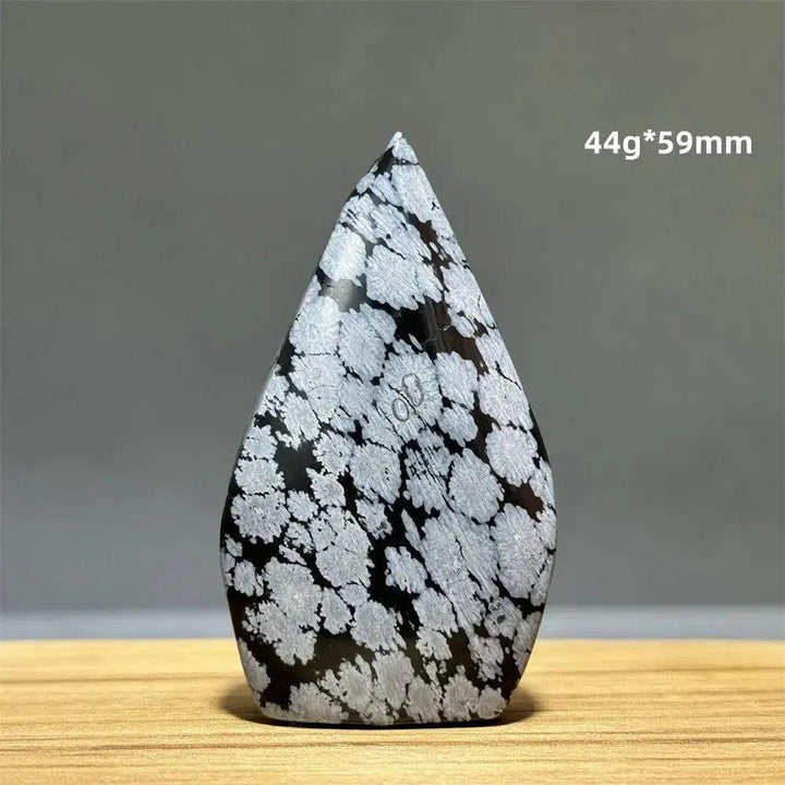 Snowflake Obsidian freeform torch from Crystal Destiny, featuring black volcanic glass with white snowflake patterns.