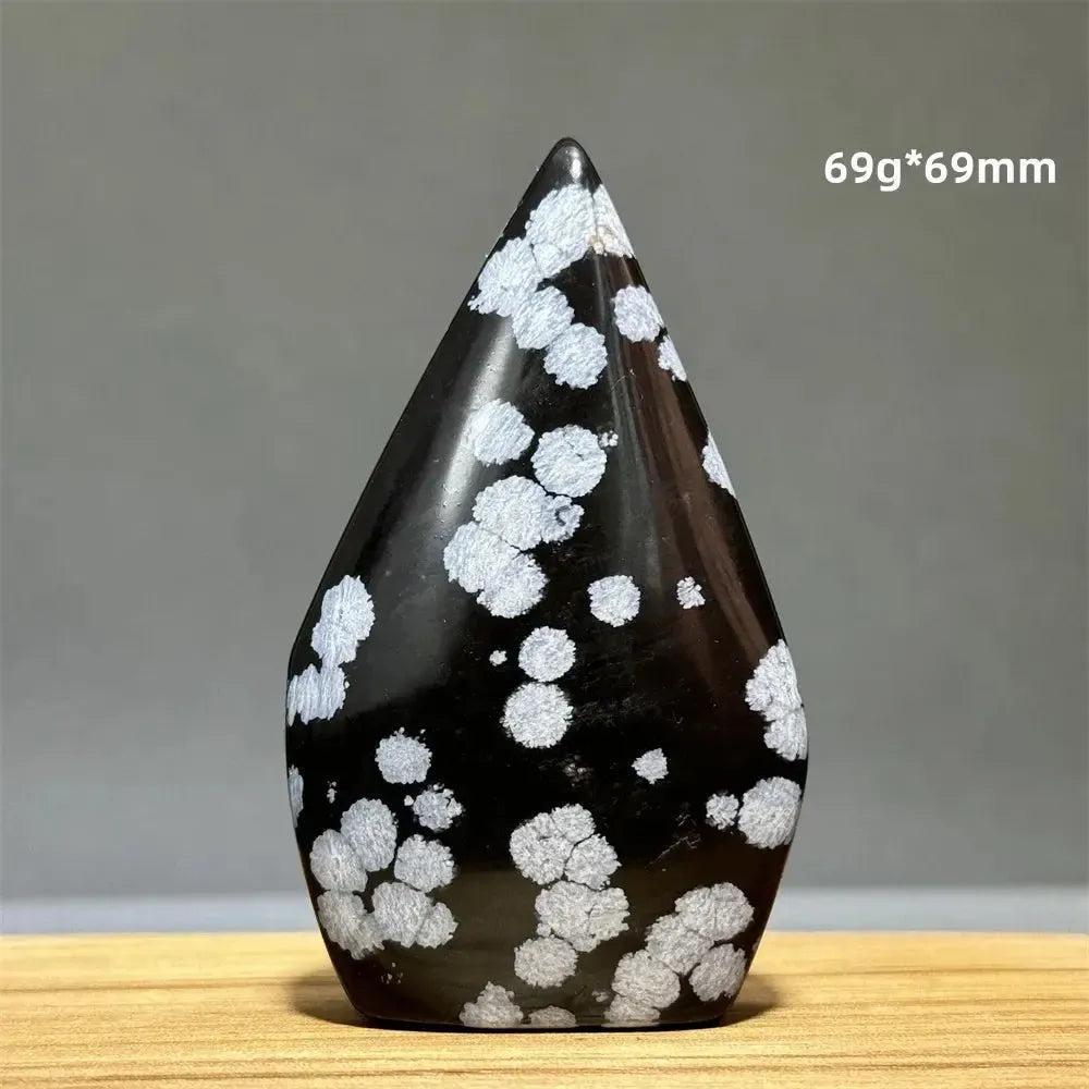 Snowflake Obsidian freeform torch from Crystal Destiny, featuring black volcanic glass with white snowflake patterns.