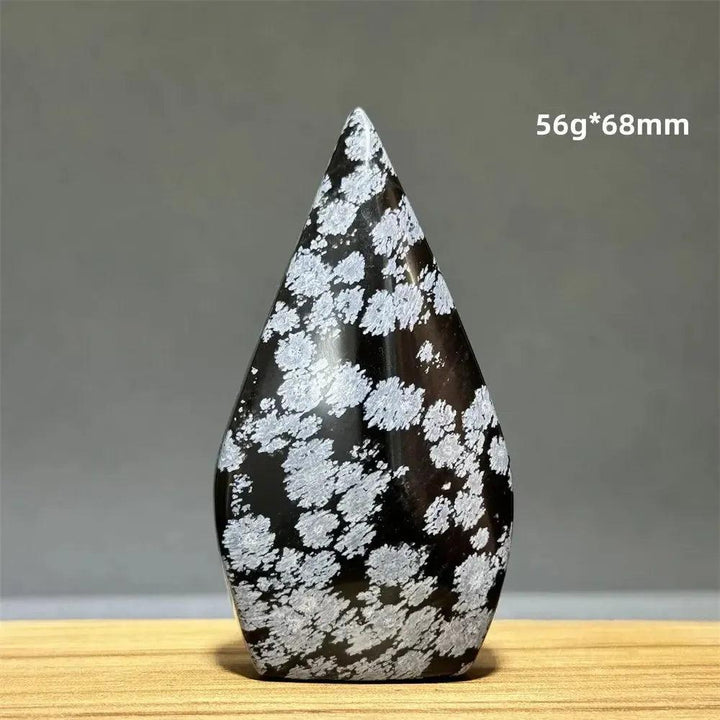 Snowflake Obsidian freeform torch from Crystal Destiny, 56g, 68mm, with white snowflake patterns on black.