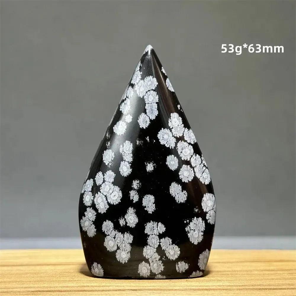 Snowflake Obsidian freeform torch from Crystal Destiny, a black crystal with white snowflake patterns.