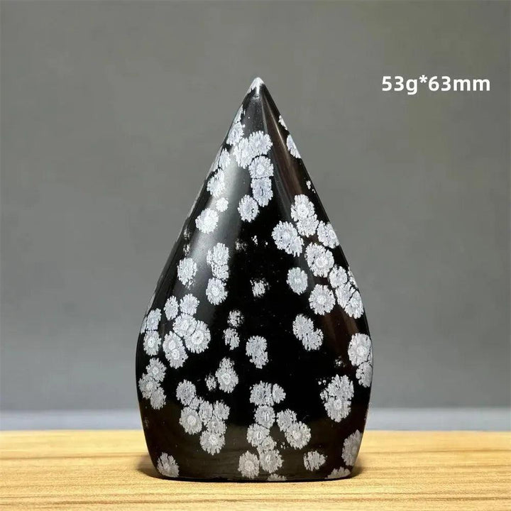 Snowflake Obsidian freeform torch from Crystal Destiny, a black crystal with white snowflake patterns.