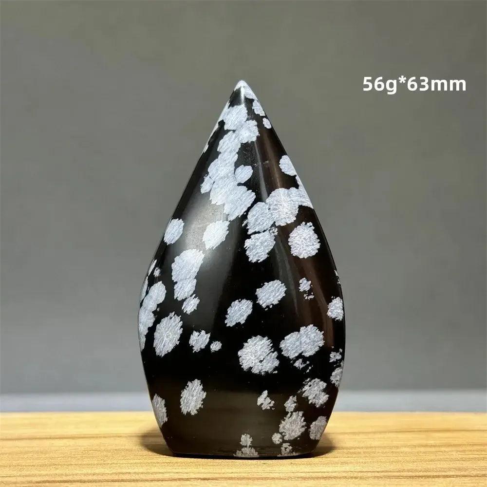 Snowflake Obsidian freeform torch from Crystal Destiny, a black volcanic glass with white snowflake patterns.