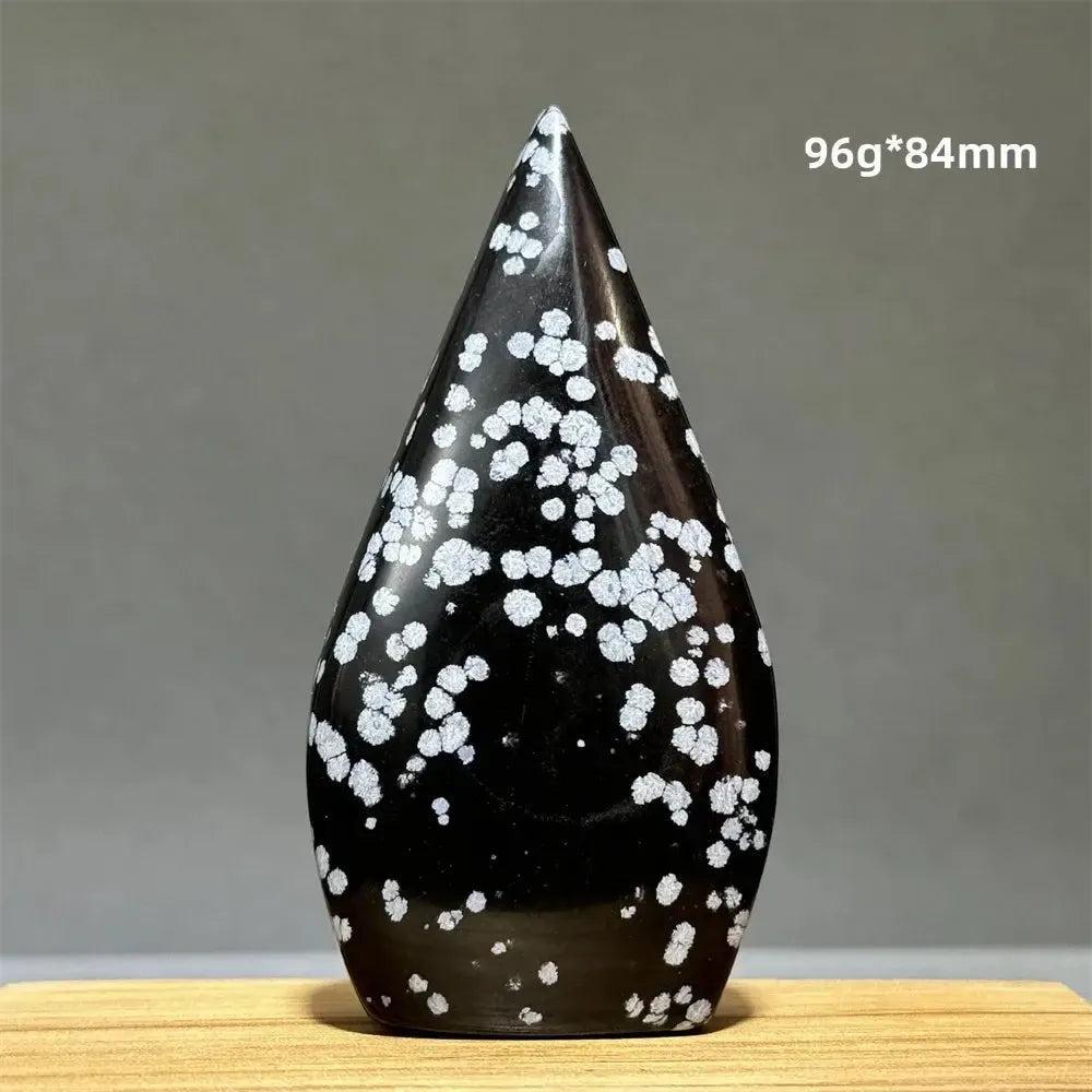 Snowflake Obsidian freeform torch from Crystal Destiny, a black crystal with white snowflake-like patterns.