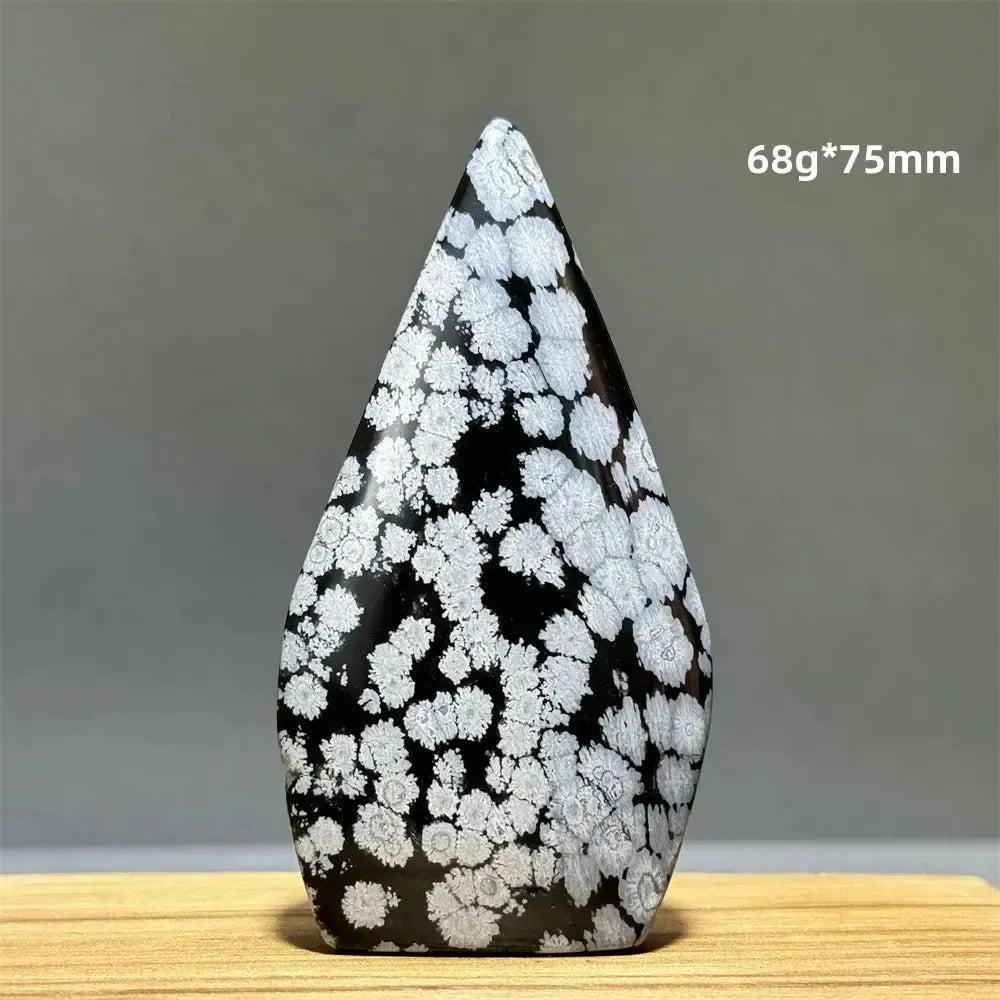 Snowflake Obsidian freeform torch from Crystal Destiny, featuring black volcanic glass with white cristobalite snowflake patterns.