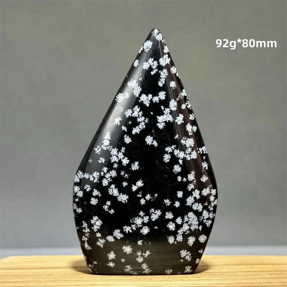 Snowflake Obsidian freeform torch from Crystal Destiny, a black crystal with white snowflake patterns.