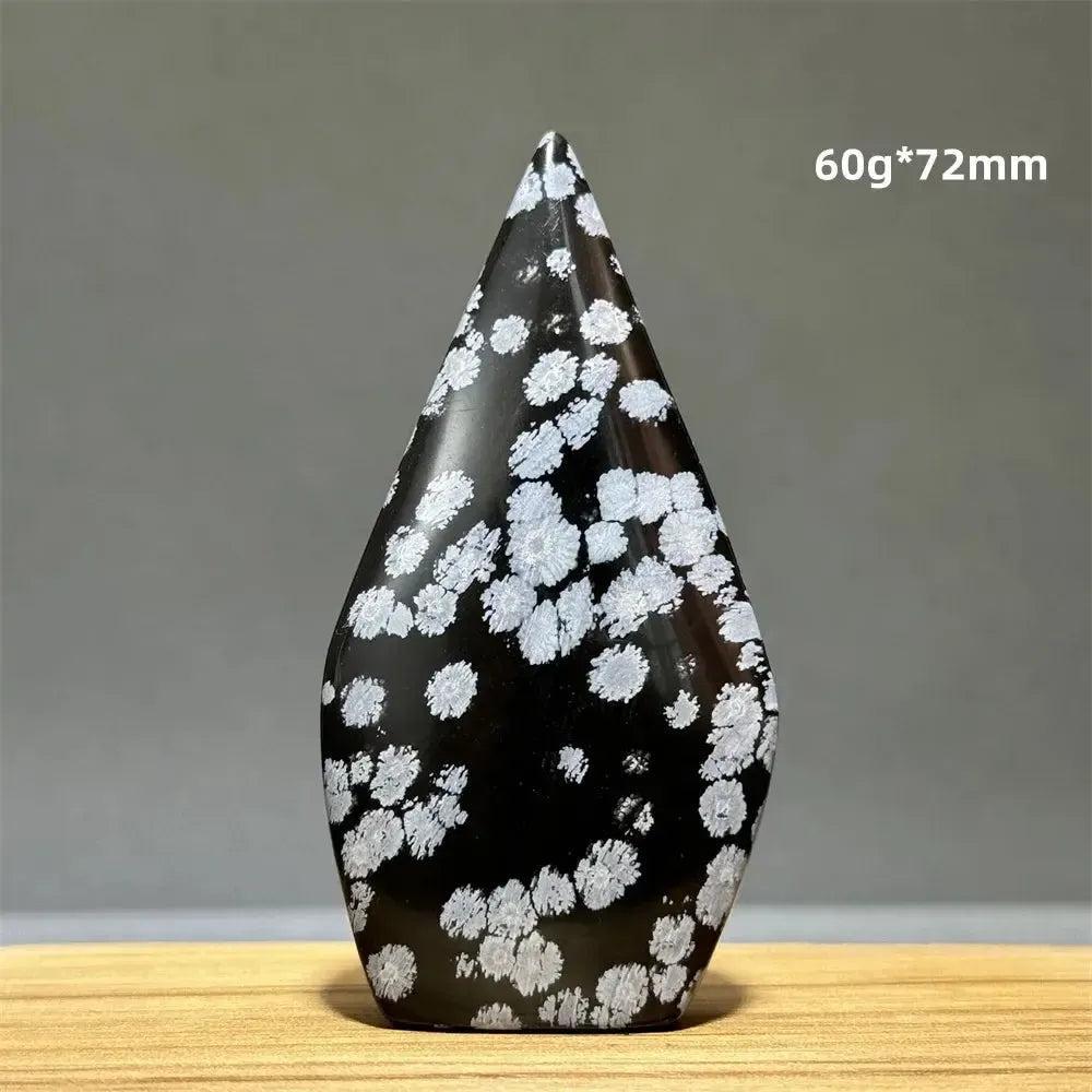 Black Snowflake Obsidian freeform torch from Crystal Destiny, with white snowflake-like patterns.