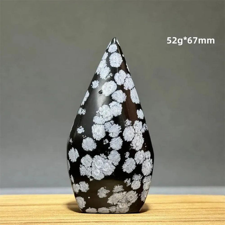 Snowflake Obsidian freeform torch from Crystal Destiny, featuring black volcanic glass with white snowflake patterns.