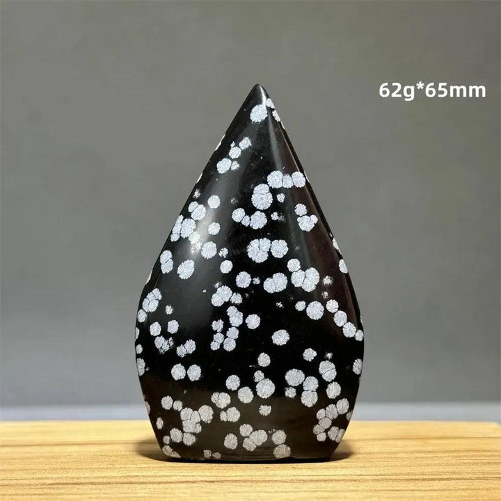 Snowflake Obsidian freeform torch from Crystal Destiny, a black crystal with white snowflake patterns.