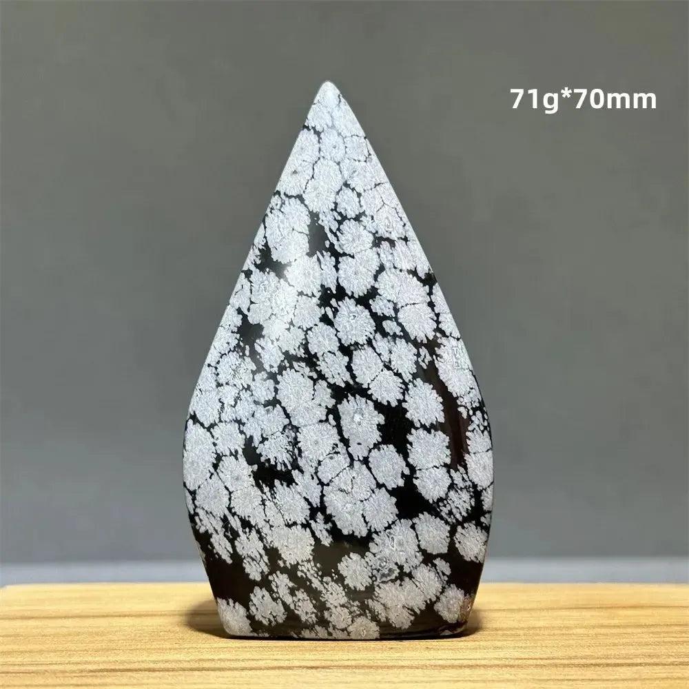 Snowflake Obsidian freeform torch from Crystal Destiny, featuring black volcanic glass with white snowflake patterns.