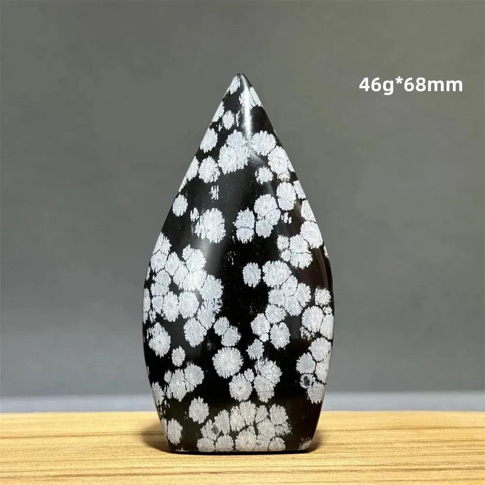 Snowflake Obsidian freeform torch from Crystal Destiny, a black crystal with white snowflake patterns.