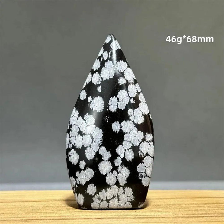 Snowflake Obsidian freeform torch from Crystal Destiny, a black crystal with white snowflake patterns.