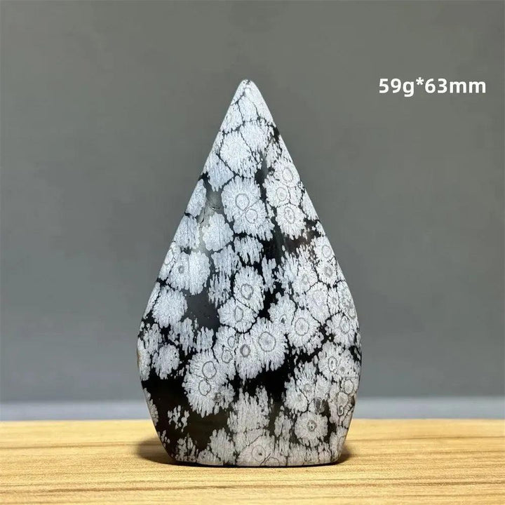Snowflake Obsidian freeform torch from Crystal Destiny, featuring black volcanic glass with white snowflake patterns.