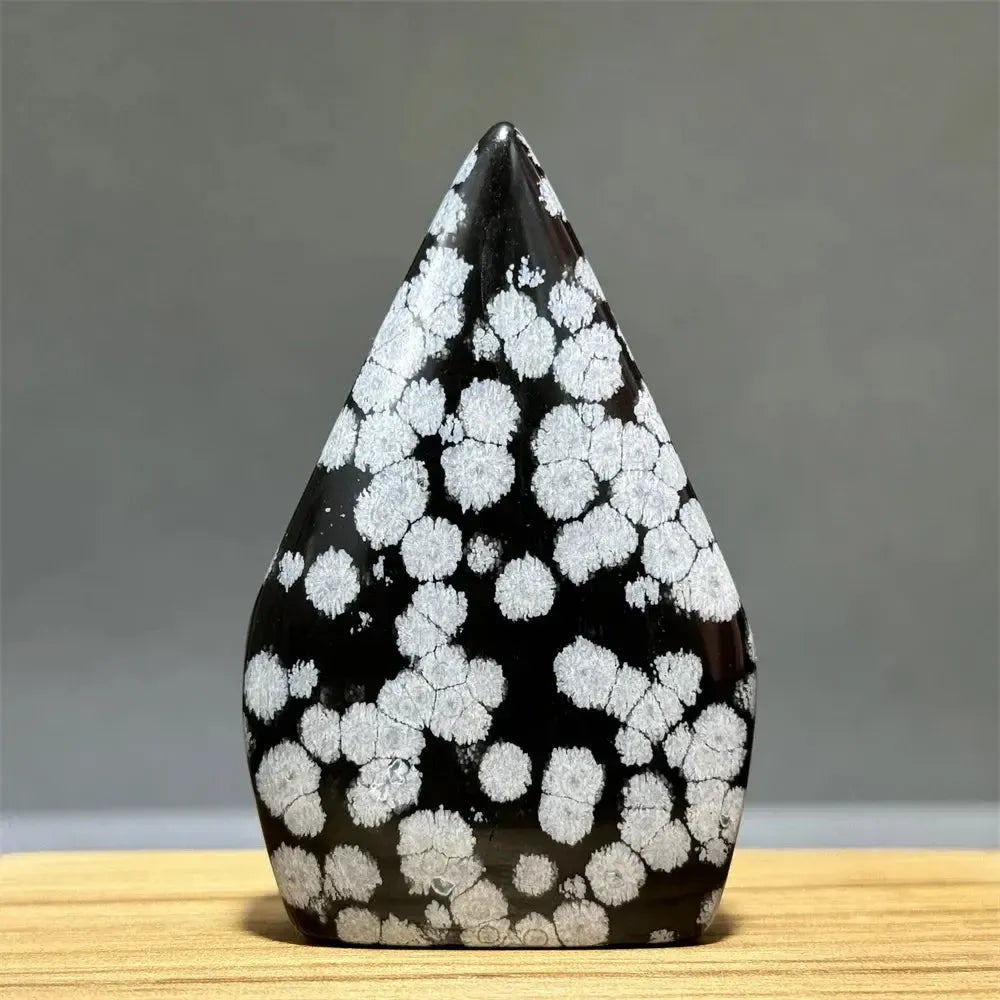 Black Snowflake Obsidian freeform torch from Crystal Destiny with white snowflake-like patterns, for gentle self-reflection.