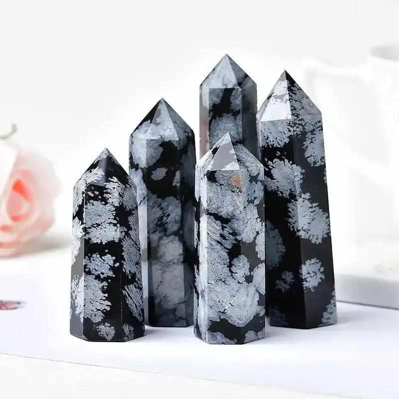 Polished Snowflake Obsidian towers with black volcanic glass and white snowflake patterns for grounding and balance.