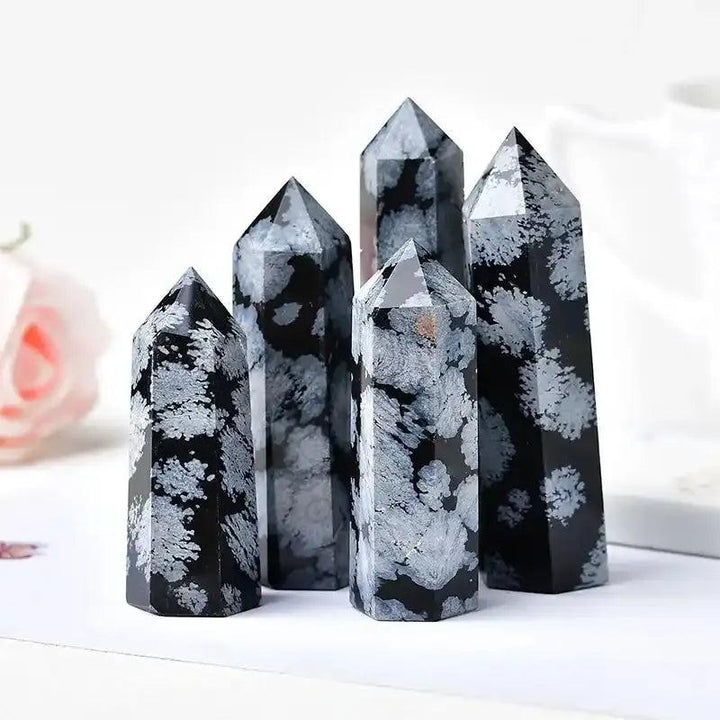 Polished Snowflake Obsidian towers with black volcanic glass and white snowflake patterns for grounding and balance.
