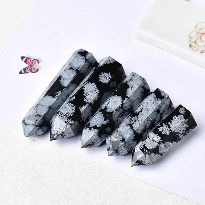 Polished Snowflake Obsidian towers featuring black volcanic glass with white snowflake patterns for grounding and balance.