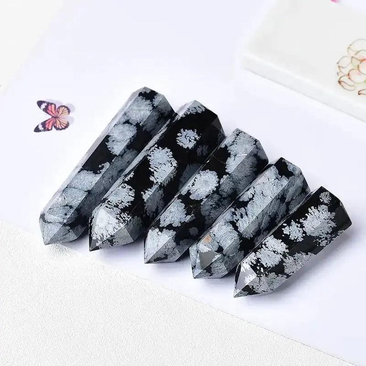 Polished Snowflake Obsidian towers featuring black volcanic glass with white snowflake patterns for grounding and balance.