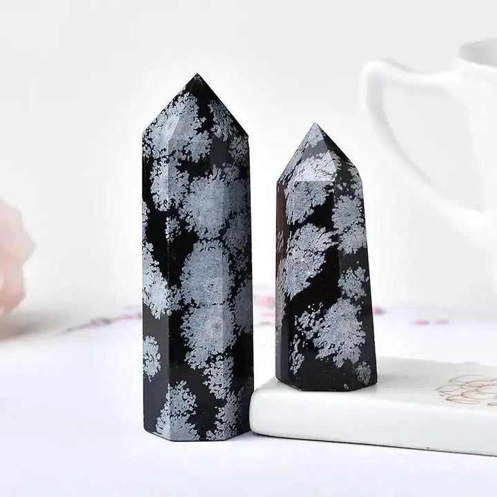 Polished Snowflake Obsidian tower with black volcanic glass and white snowflake patterns for grounding and balance.