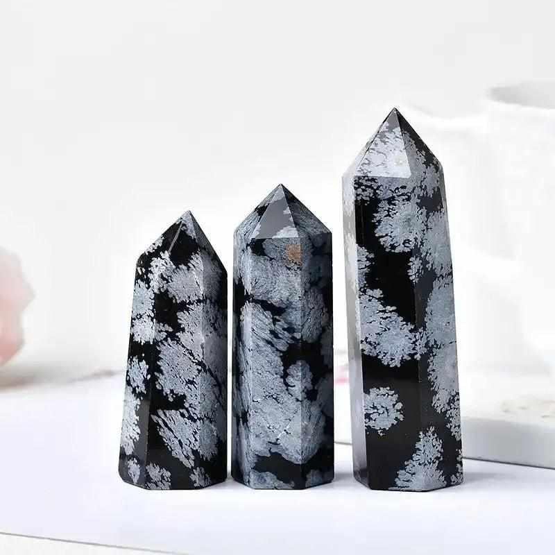 Polished Snowflake Obsidian towers with black volcanic glass and white snowflake patterns for grounding and balance.