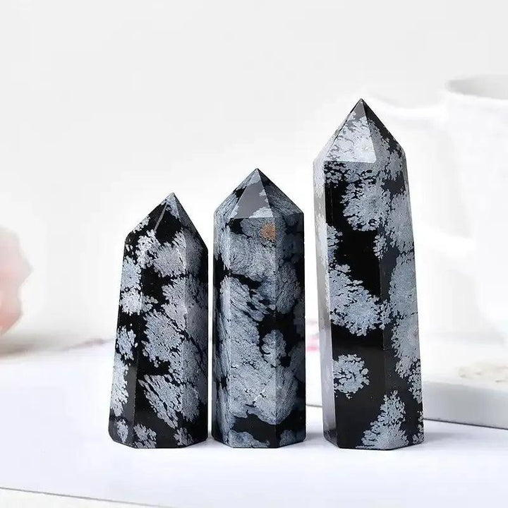 Polished Snowflake Obsidian towers with black volcanic glass and white snowflake patterns for grounding and balance.