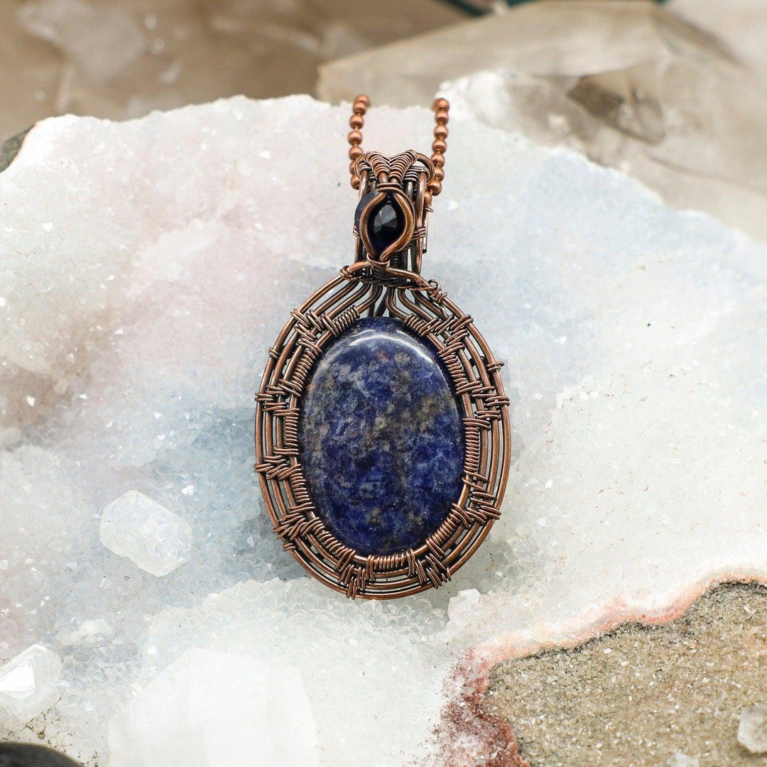 Sodalite Oval Wire Wrap Pendant 2.25 Inch: Deep blue sodalite with white veining, handcrafted in healing copper wire.