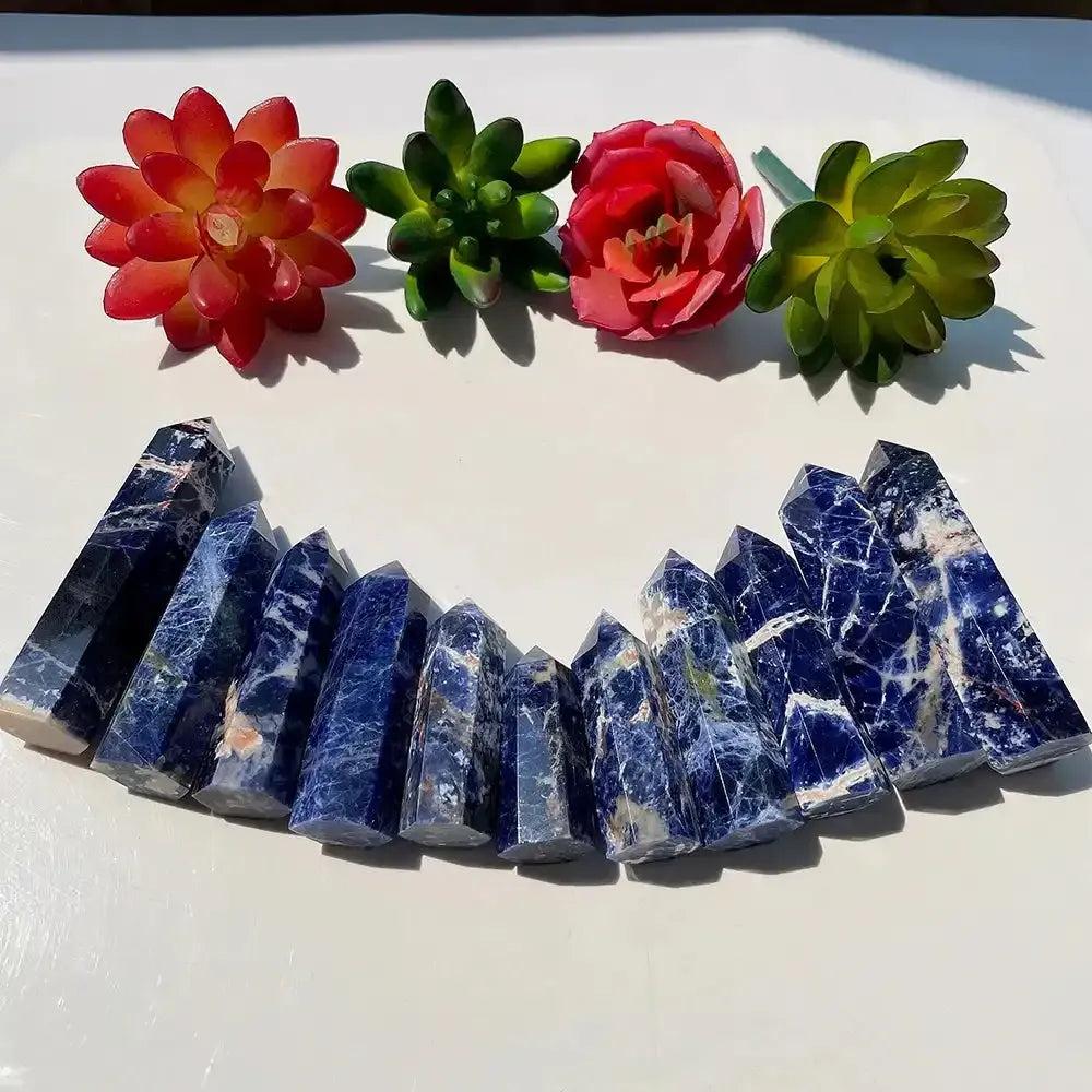 Polished Sodalite crystal point tower for healing, featuring deep blue natural stone with white mineral veins.