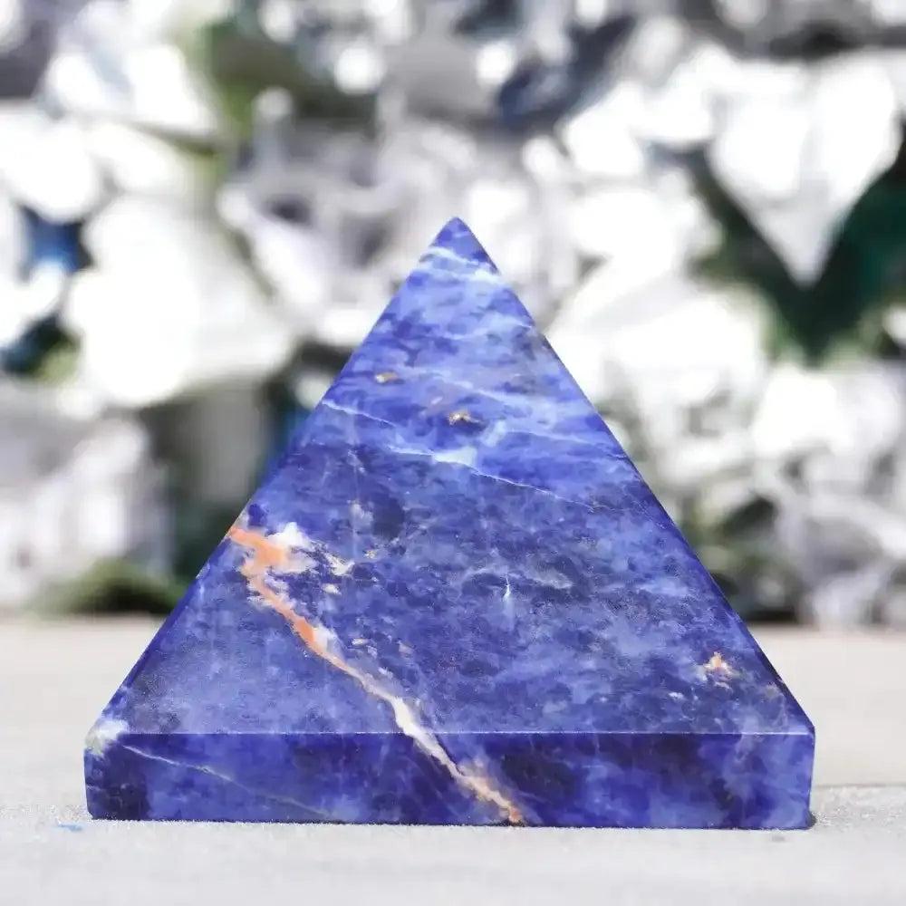 Deep blue Natural Sodalite Crystal Pyramid with unique white and orange veins, perfect for elegant home decor and healing.