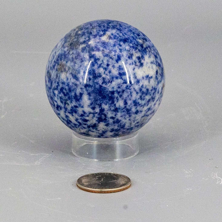 Sodalite Sphere 56mm: Deep blue crystal with white calcite veining, a smooth, polished display piece.