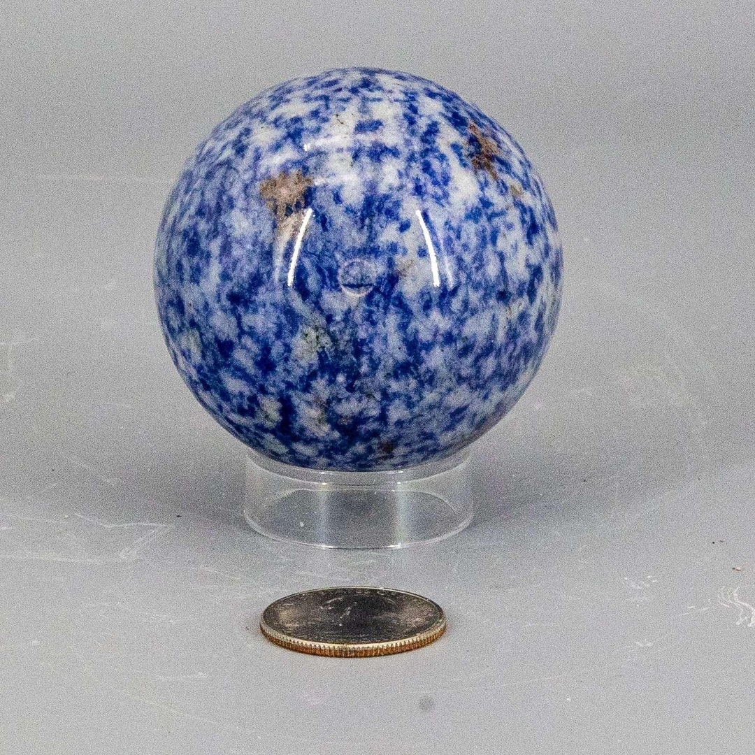 Sodalite Sphere 56mm: Deep blue crystal sphere with white calcite veining, a smooth, even polish, and a clear stand.