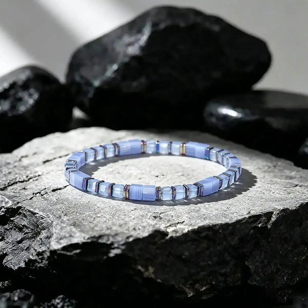 Sodalite cube bead bracelet with iridescent copper spacers for throat chakra clarity and thoughtful expression.