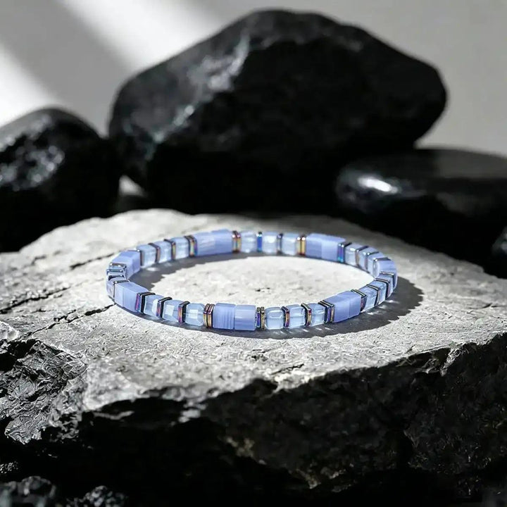 Sodalite cube bead bracelet with iridescent copper spacers for throat chakra clarity and thoughtful expression.