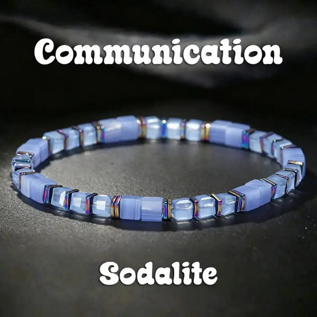 Sodalite cube bead bracelet featuring pale blue stones, iridescent copper spacers, and throat chakra clarity.