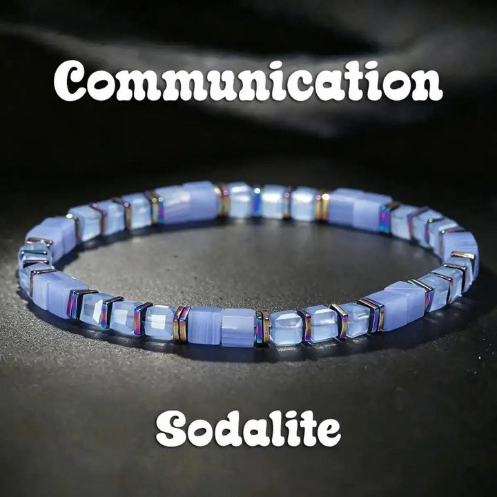 Sodalite cube bead bracelet featuring pale blue stones, iridescent copper spacers, and throat chakra clarity.