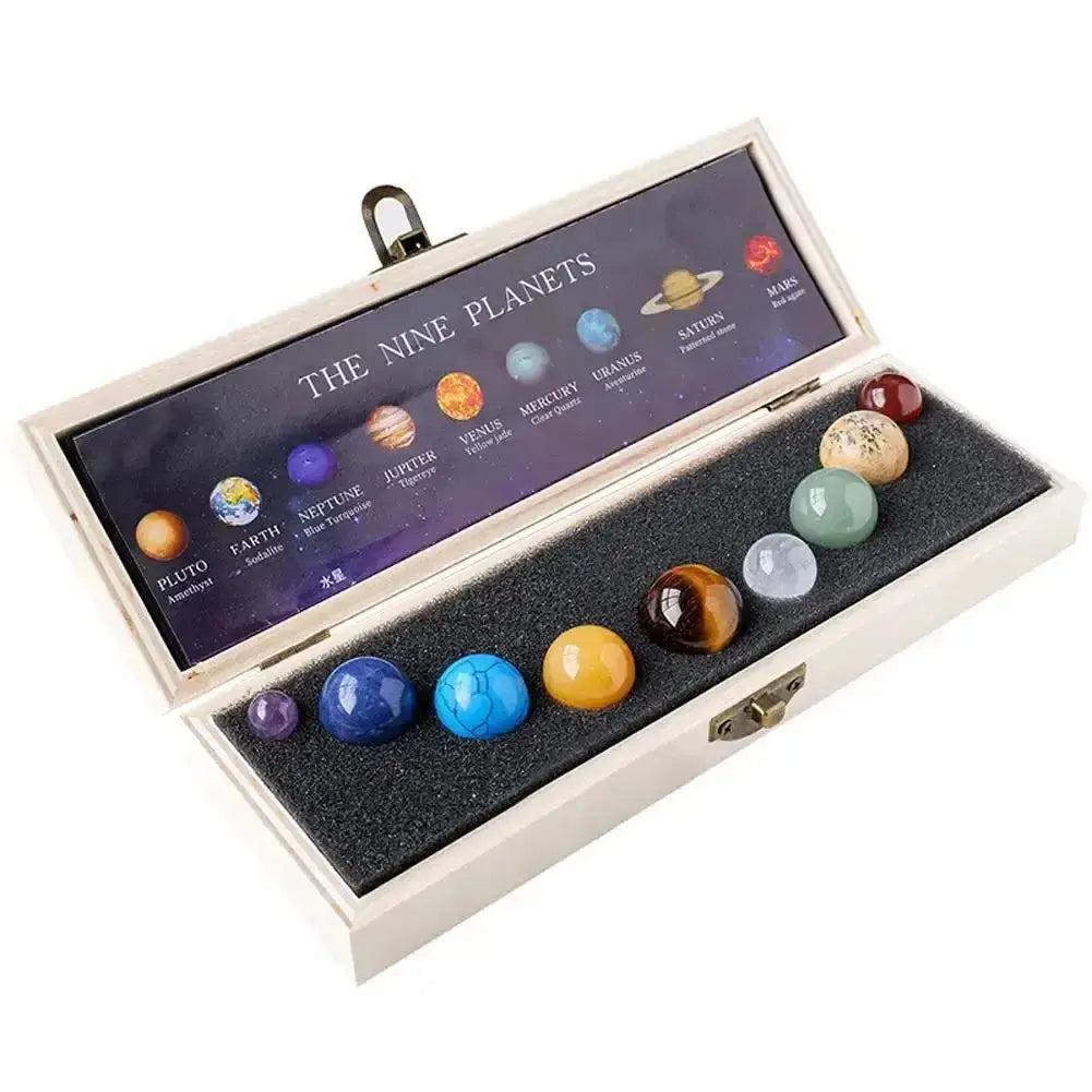 Nine polished natural gemstone planets in a wooden box, representing the solar system from Crystal Destiny.