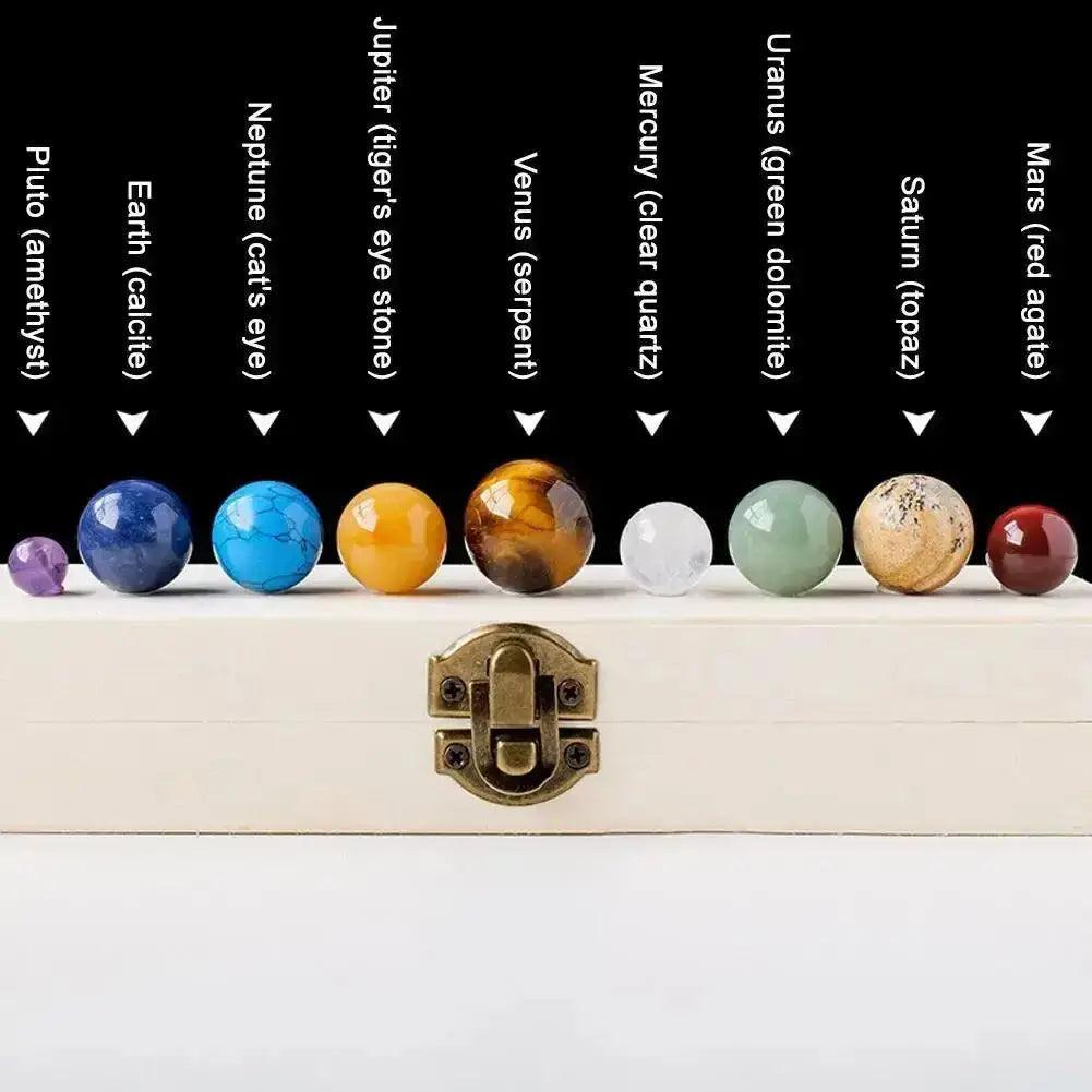 Nine polished natural gemstone planets, including amethyst and red agate, in a crystal set.