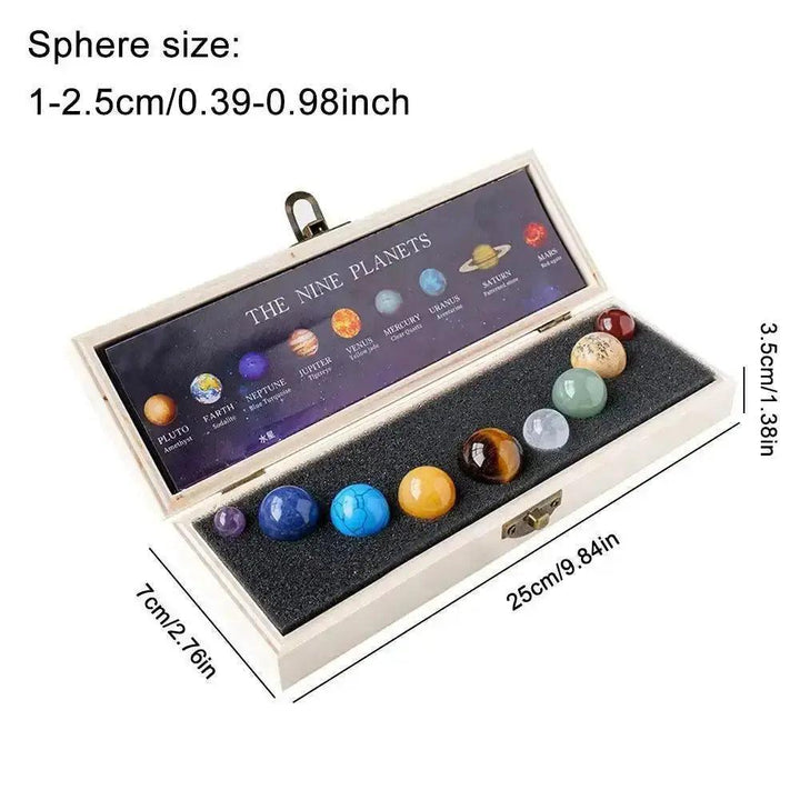 Nine polished natural gemstone planets in a wooden display box, representing the Solar System.