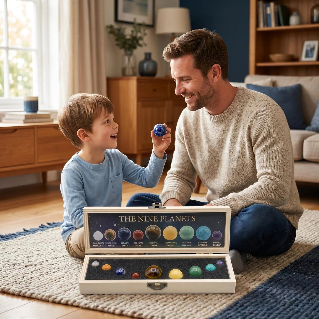 Father and son exploring the Solar System Nine Planets Crystal Set featuring colorful gemstone spheres in a wooden box.