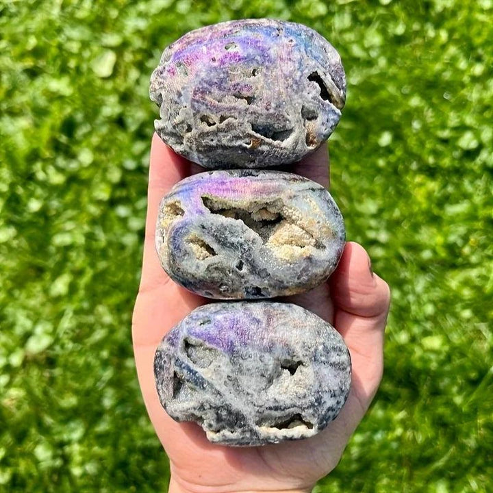 Sparkling Druzy Sphalerite Titanium Bubble Palm Stones with vibrant purple sheen and natural crystal cavities.
