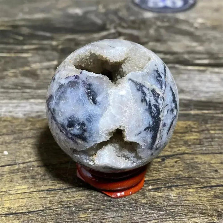 Striking Sphalerite geode sphere with metallic luster, amber tones, and grounding energy, on a display stand.