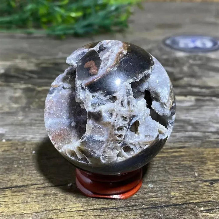 Polished Sphalerite Sphere with Stand, showcasing metallic luster, rich amber to dark brown tones, and unique natural variations.