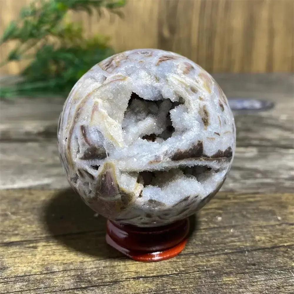 Unique Sphalerite Geode Sphere with Stand, showcasing raw crystal formations and grounding energy.